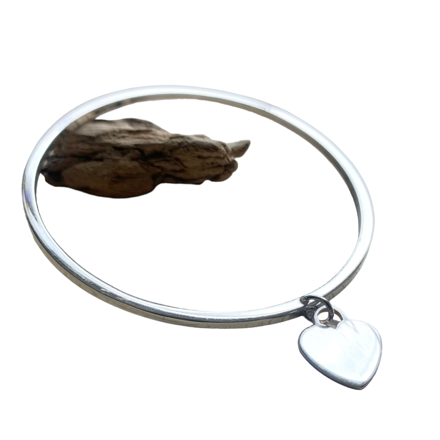 Close-up of handcrafted sterling silver heart charm bangle detail – TG-Jewellery