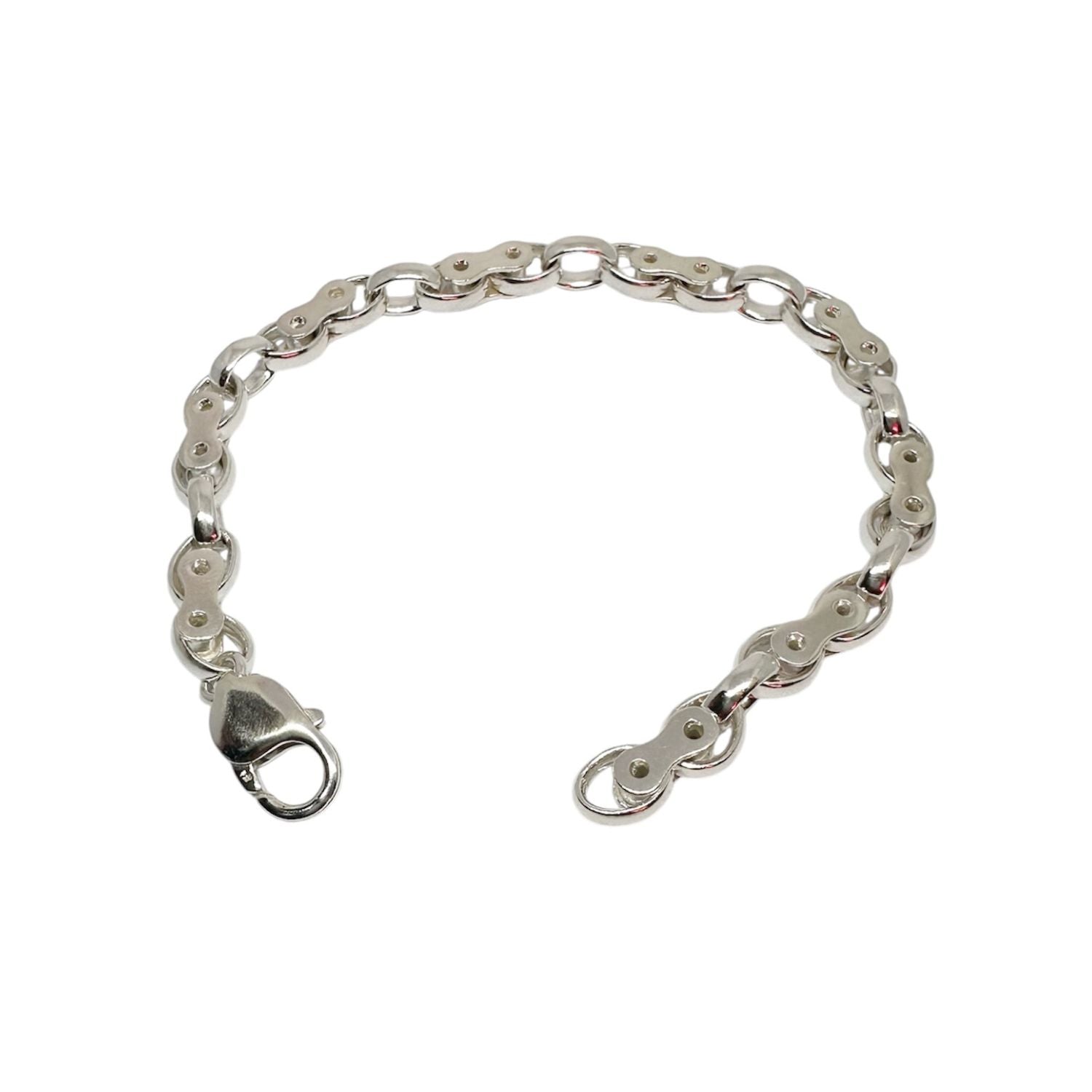 Handcrafted sterling silver biker link bracelet with alternating oval and connector links, polished finish and lobster clasp, shown against a neutral background.