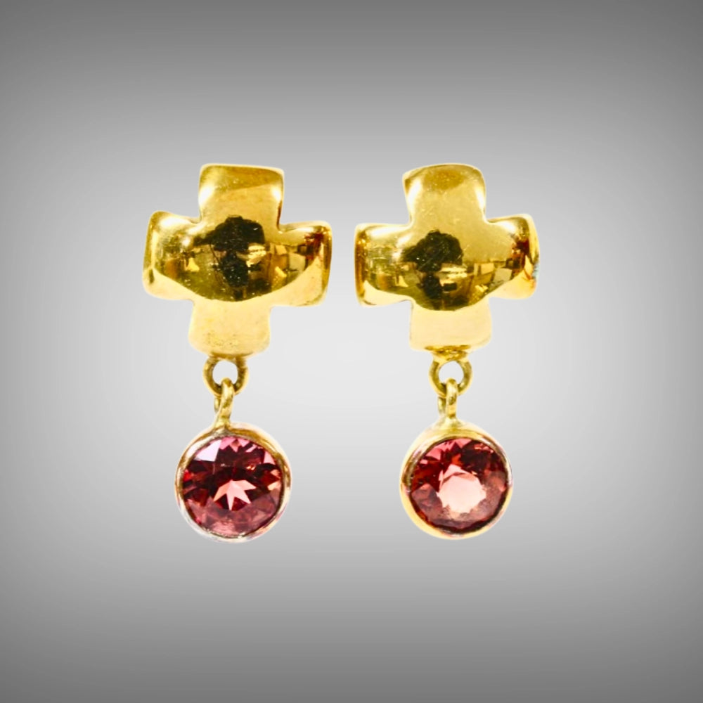 A pair of 18ct yellow gold stud earrings with a textured cross-shaped post and a dangling round faceted pink tourmaline, Tg-jewellery by Tamara Gervasio