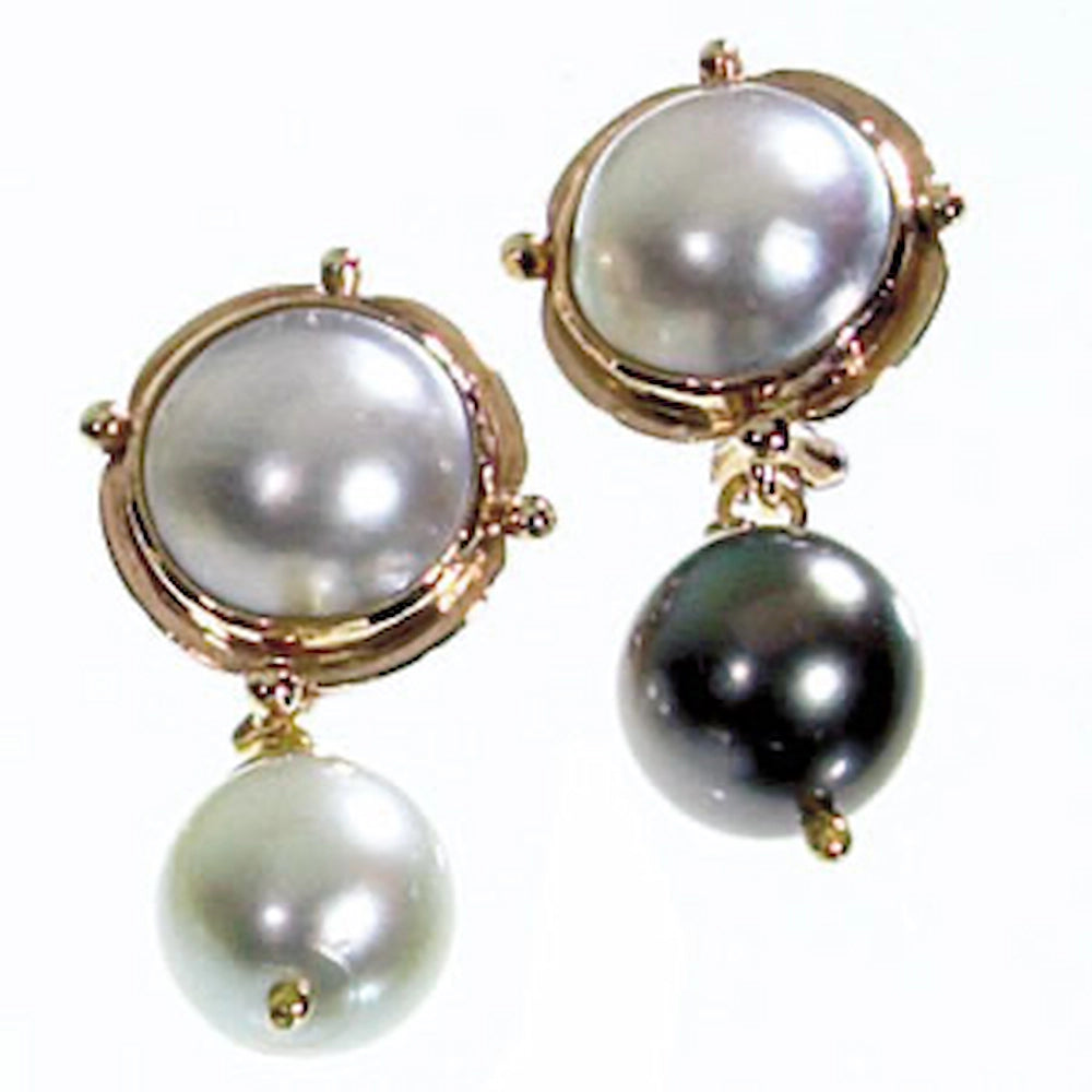 A pair of gold drop earrings featuring large round white freshwater pearls on the top and smaller dark black pearls hanging below, Tg-Jewellery