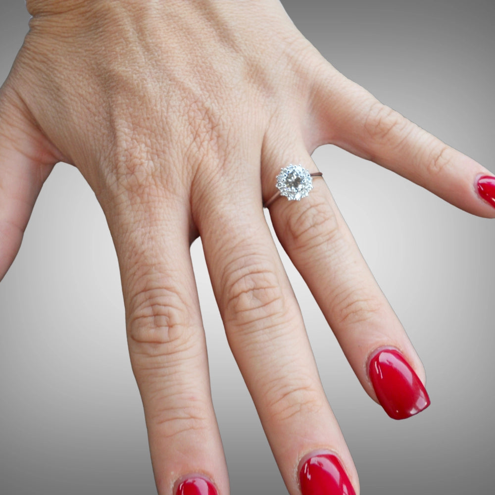 A close-up of a hand wearing a solitaire diamonds 18ct white gold ring by Tamara Gervasio