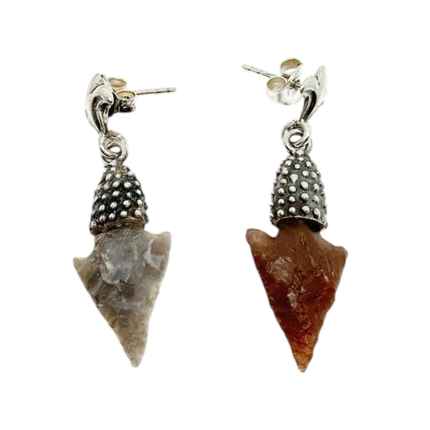 Pair of arrowhead-shaped earrings with silver tops on a white background