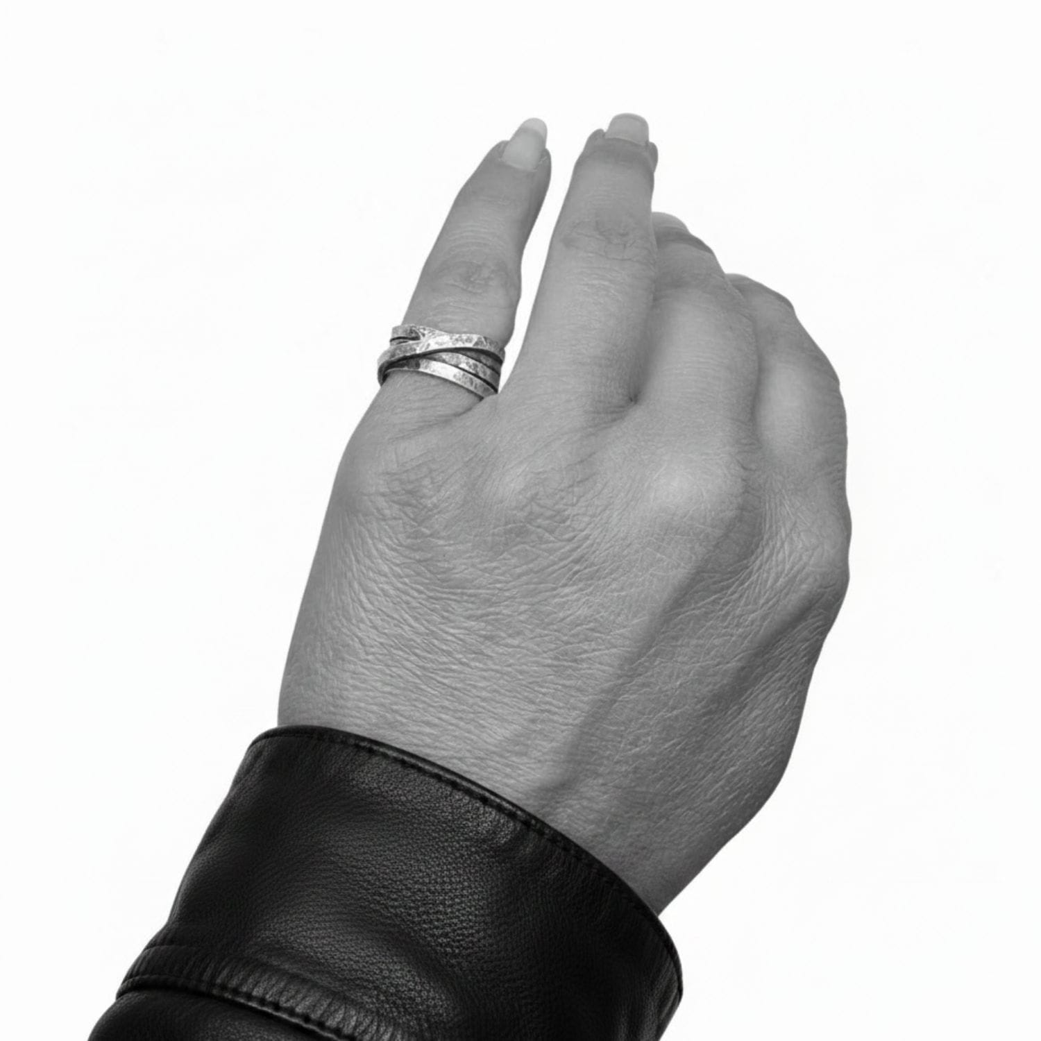 Model wearing recycled sterling silver 925 Fasce Ring, showing organic layered band form and scale on hand