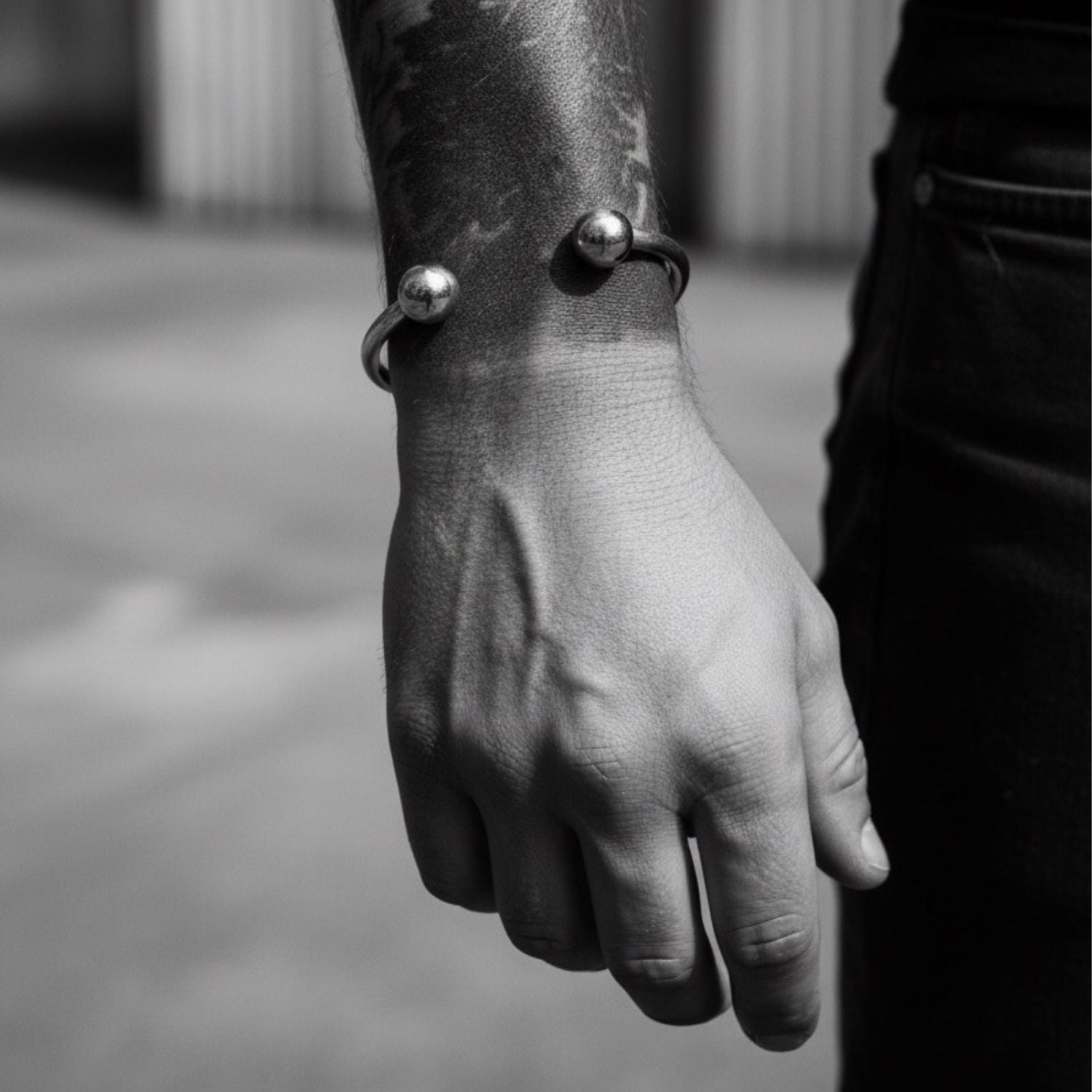 Close-up of a hand wearing a bracelet with spherical elements