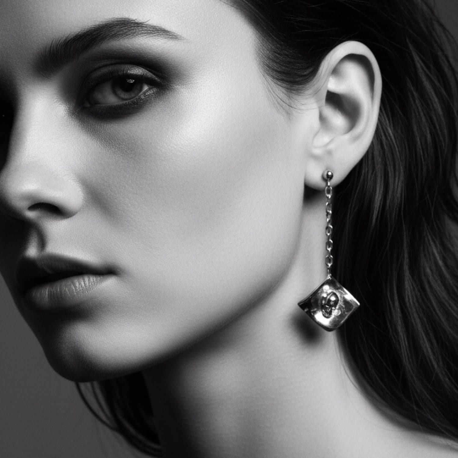 Model wearing sterling silver skull dangle earrings, gothic jewellery by Tamara Gervasio
