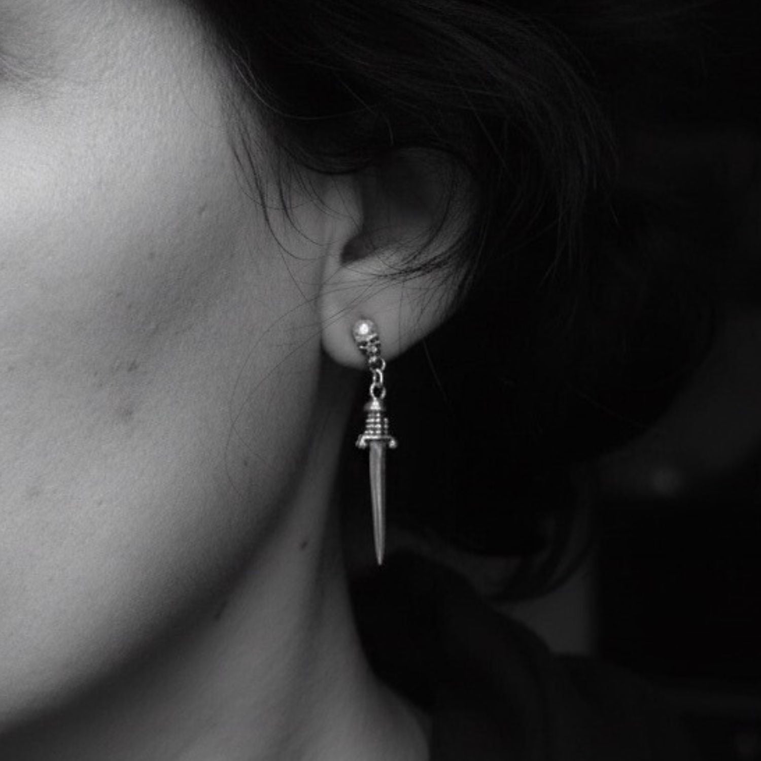 Model wearing skull dagger dangle earrings in recycled sterling silver 925 – Tg-Jewellery by Tamara Gervasio