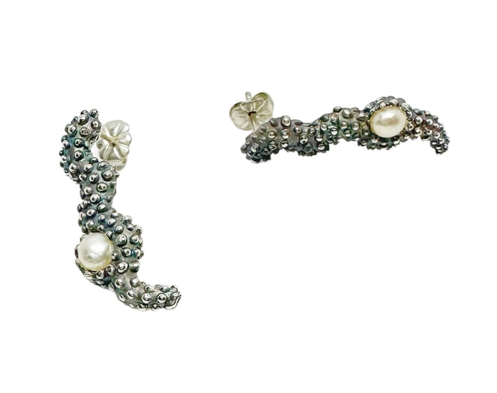 Pair of silver and pearl earrings on a white background