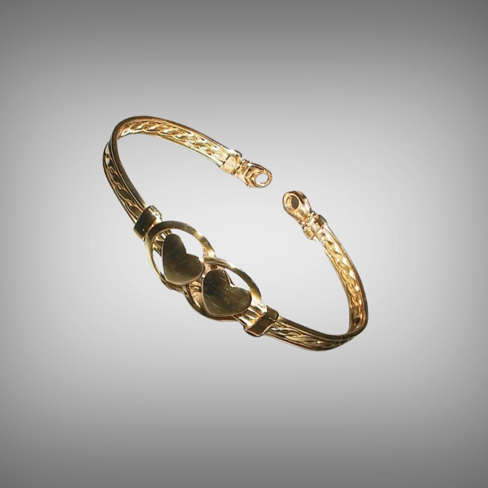 A gold 18ct yellow cuff bracelet with a central heart motif and textured bands, handmade from lost wax carving Tg-Jewellery by Tamara Gervasio