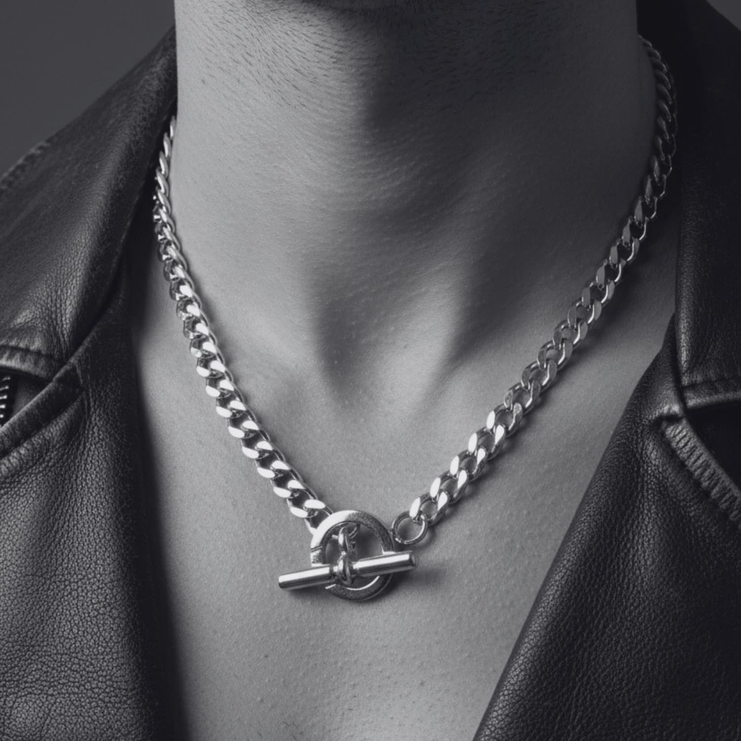 Men's sterling silver curb chain necklace worn — showing collarbone length at 48.5cm, clean polished links and T-bar clasp detail