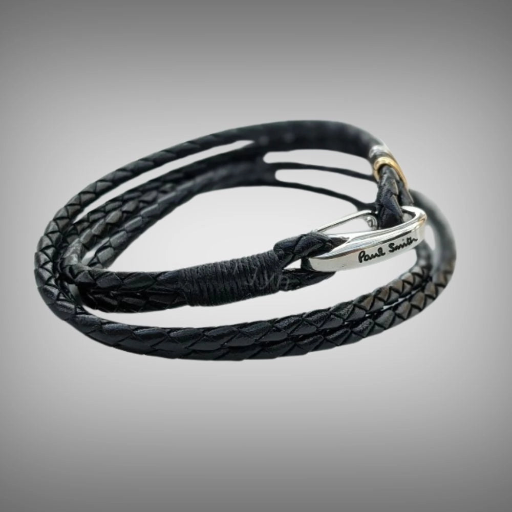 A black braided leather bracelet with a sterling silver clasp engraved with the brand name 'Paul Smith', TG-Jewellery by Tamara Gervasio