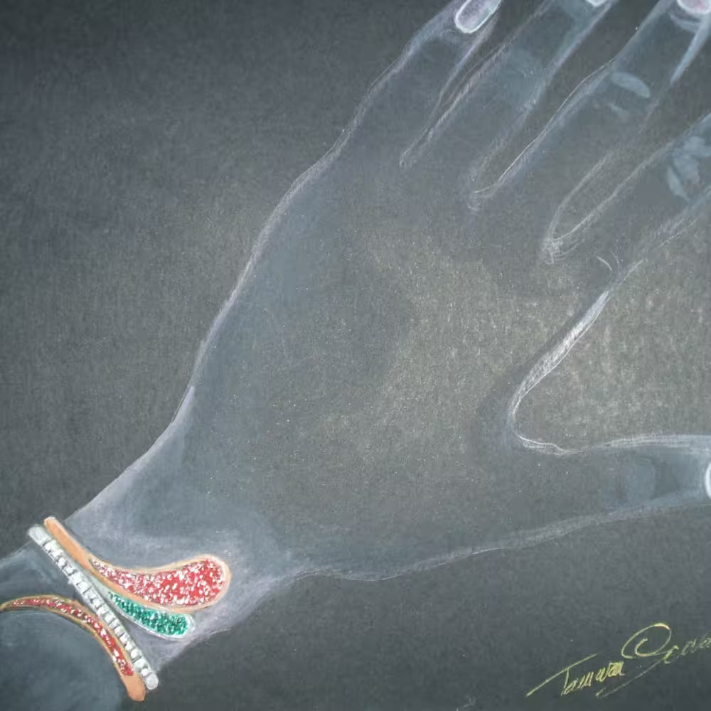 Sketch bangle in white gold and rose gold-toned with ruby, emeralds and diamonds shown on the wrist. Tg-jewellery