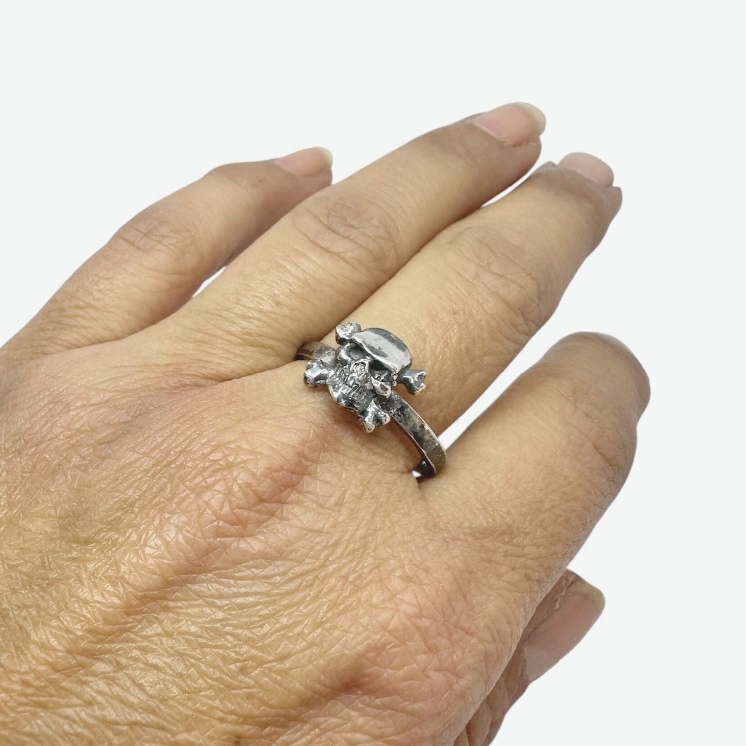 Close-up of skull face on recycled sterling silver 925 band ring – polished and oxidised finish, hand carved in Cornwall by Tamara Gervasio, Tg-Jewellery