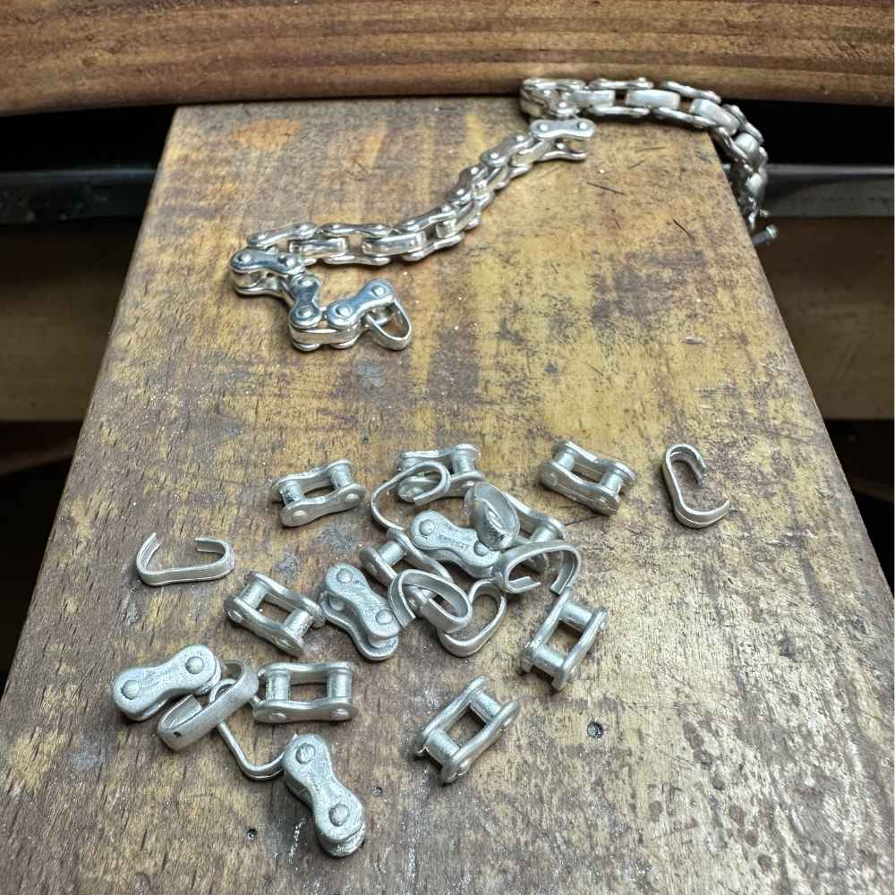 Cast silver chain link bracelet components on jewellery bench — example work from finishing and polishing session, Tg-Jewellery Cornwall