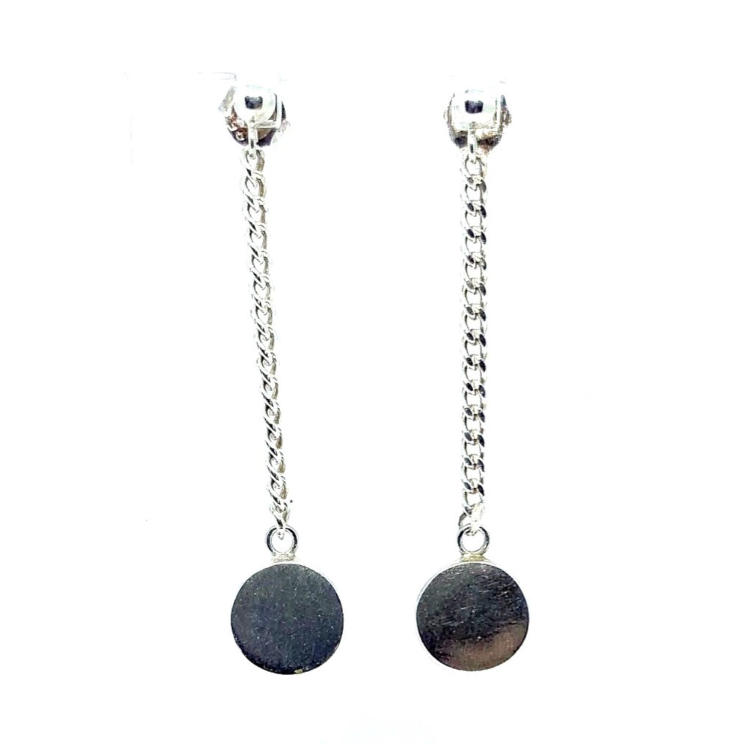 Close-up showing circular form and chain detail, lost wax cast earrings 