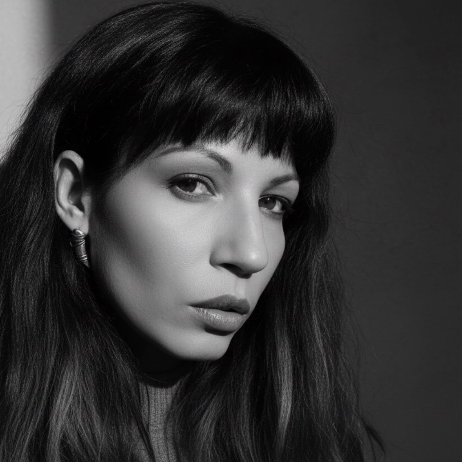 Model wearing sterling silver 925 eyebrow stud earrings inspired by H.R. Giger – TG-Jewellery