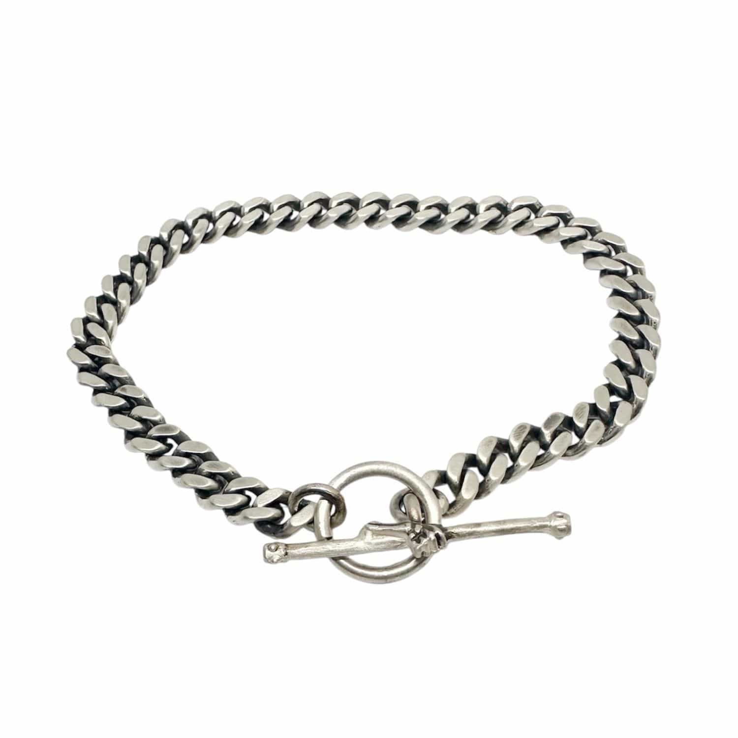 Close-up of lost wax carved skeletal hand T-bar clasp, satin and oxidised finish – Tg-Jewellery by Tamara Gervasio