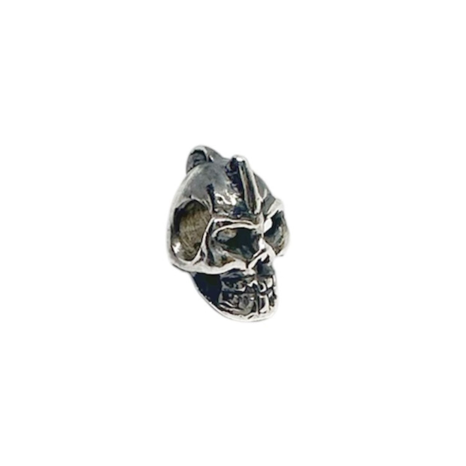 Close-up of punk skull bead pendant in sterling silver 925, deep carved facial detail and polished highlights