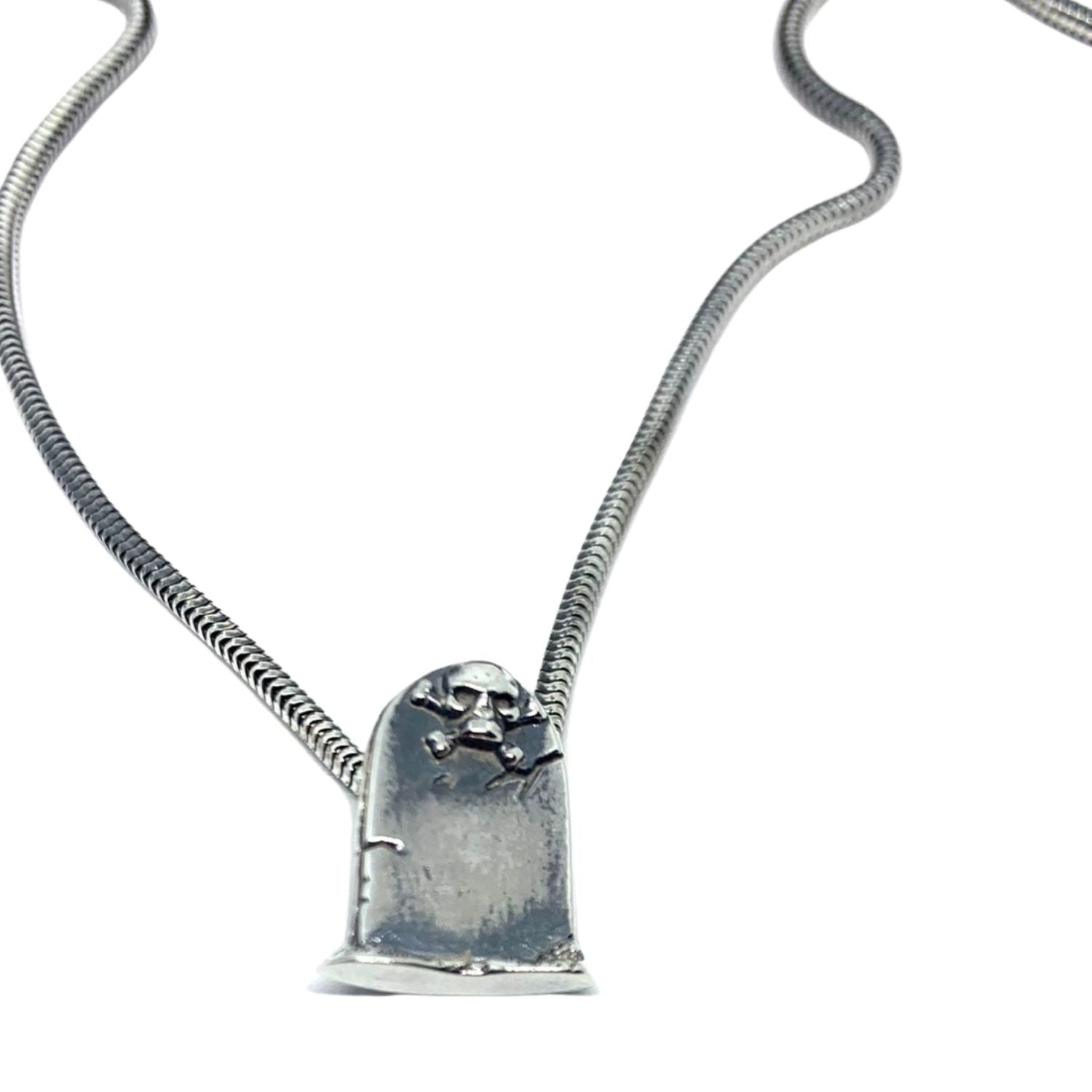Close-up of lost wax carved skeleton grave pendant in sterling silver 925, oxidised and polished finish – Tg-Jewellery by Tamara Gervasio