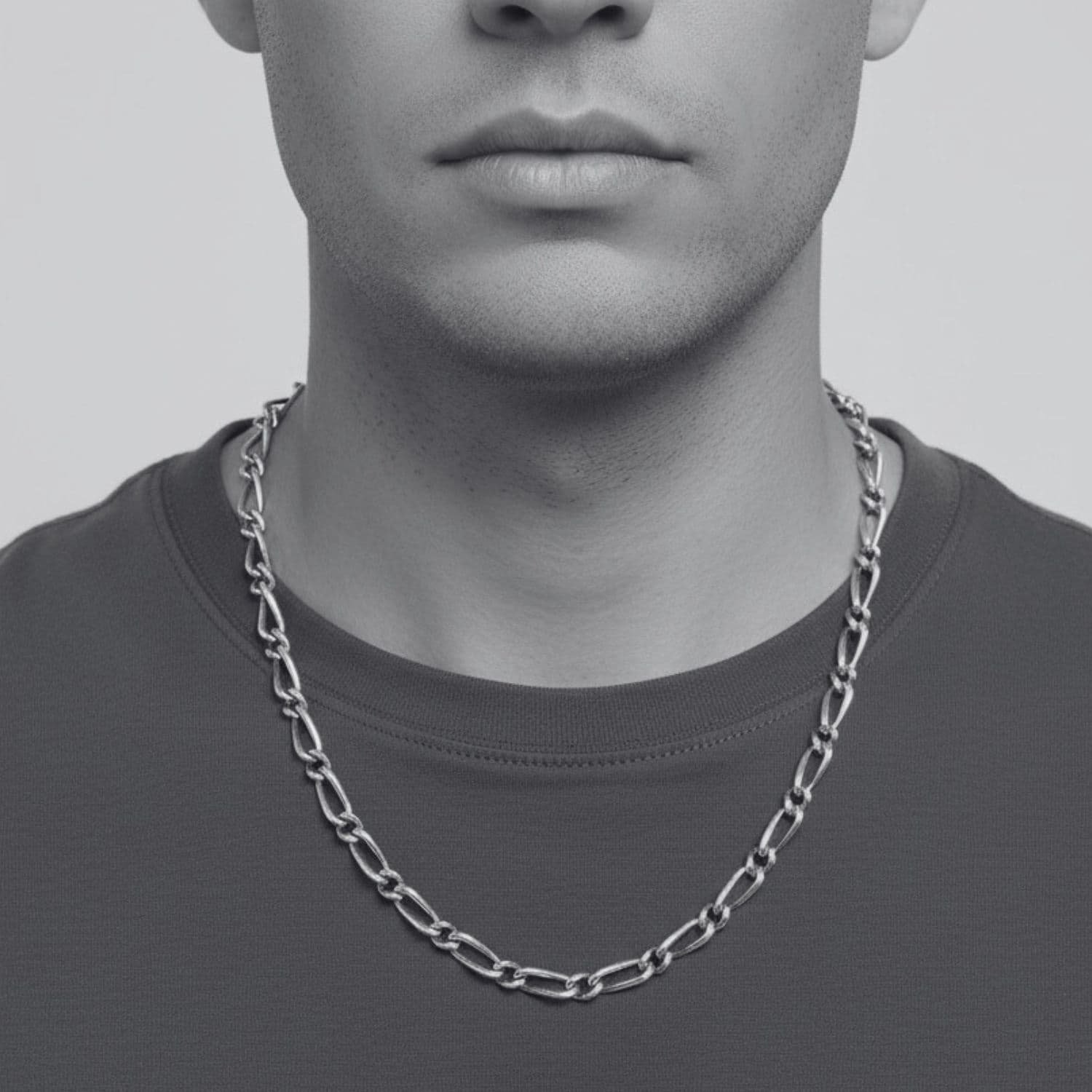 Men's sterling silver Figaro chain necklace worn, showing alternating link pattern and oxidised finish, Tg-Jewellery