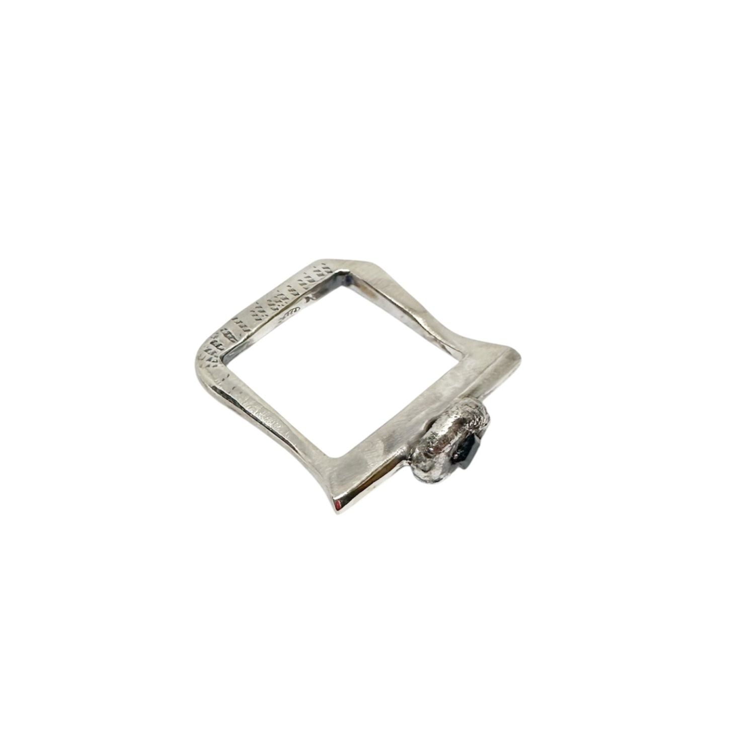 Handcrafted recycled sterling silver ring with angular band and molten pebble setting holding a 3.5mm square sapphire, partially emerging from the surface - Tg-jewellery By Tamara Gervasio