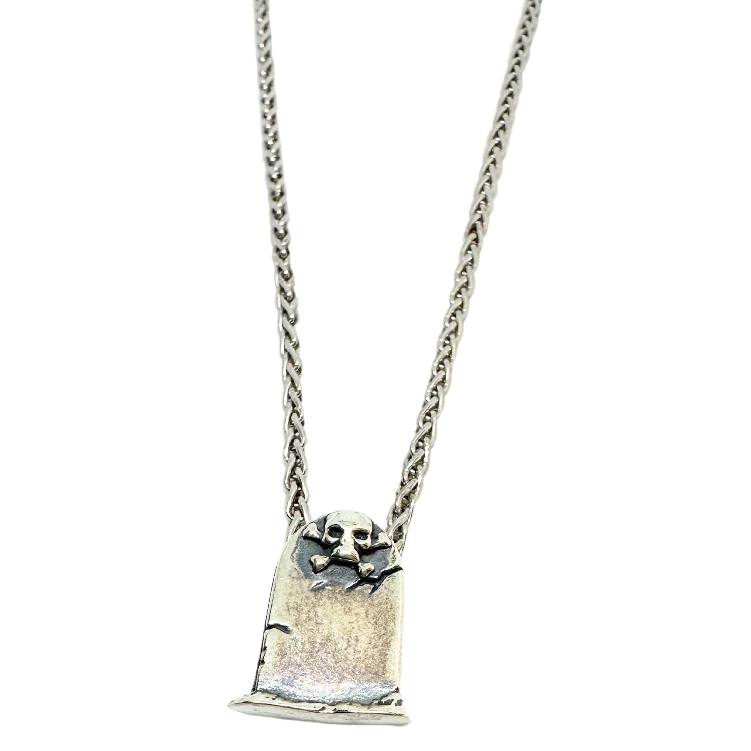 Close-up of skeleton grave pendant, polished and oxidised sterling silver 925, lost wax cast